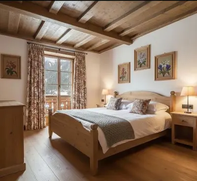 a bedroom with a large bed and a window at Dolomiti Magic in Cortina dʼAmpezzo