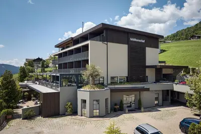 a building with a car parked in front of it at feldthurnerhof vinum-natur-relax in Feldthurns