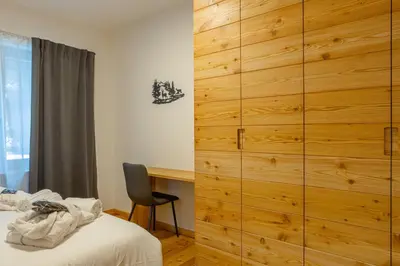 a bathroom with a shower and a sink with a mirror at DE Earth - Appartamento con Sauna in Caprile