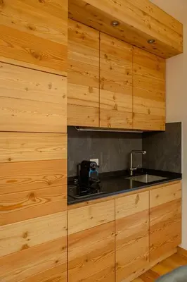 a living room with a couch and a table at DE Earth - Appartamento con Sauna in Caprile