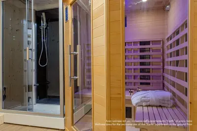a group of towels and shoes on the floor at DE Earth - Appartamento con Sauna in Caprile