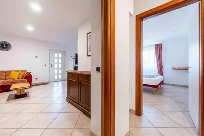 a living room with a couch and a table at Cesa Primula in Canazei