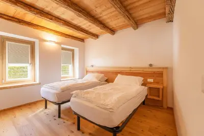 a living room with a couch and a table at Casa Vallazza - Val di Zoldo - Dolomites in Forno di Zoldo