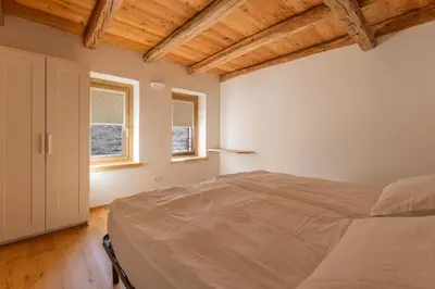 a room with a staircase and a wooden bench at Casa Vallazza - Val di Zoldo - Dolomites in Forno di Zoldo