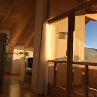 a room with a sliding glass door with a table and chairs at Ferienwohnung im schönen Südtirol in Fiumes