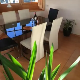 a dining room with white chairs and a table at Ferienwohnung im schönen Südtirol in Fiumes
