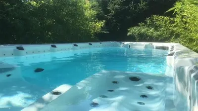 a swimming pool with blue water and rocks in it at Ferienwohnung im schönen Südtirol in Fiumes