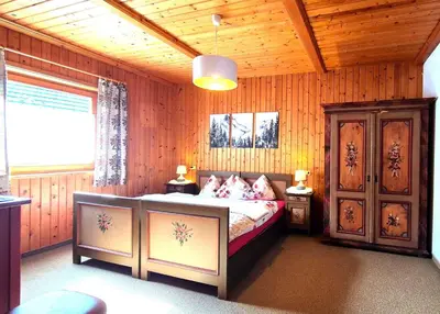 a bedroom with a bed in a wooden room at Almliesl THUR-746 in Lovara