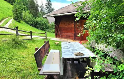 a picnic table in front of a cabin at Almliesl THUR-746 in Lovara