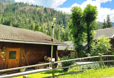 a wooden house with a fence in front of it at Almliesl THUR-746 in Lovara