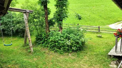a swing in a yard next to a fence at Almliesl THUR-746 in Lovara