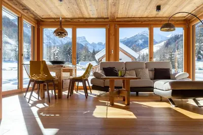 a living room with a couch and a table at Chalet Mornà in San Martino in Badia