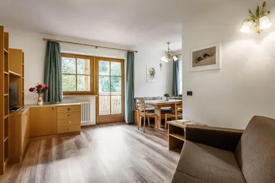 a wooden table with a potted plant on top of it at Plaön Apartments in La Villa
