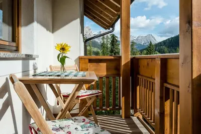 a bedroom with a bed with a night stand and a light at Plaön Apartments in La Villa