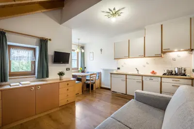 a living room with a table and a couch at Plaön Apartments in La Villa