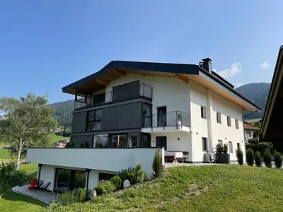 a large white house with a roof at Unterkircher Mountain Stay Relax in Terento
