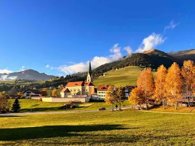 a house in the middle of a snow covered village at Unterkircher Mountain Stay Relax in Terento