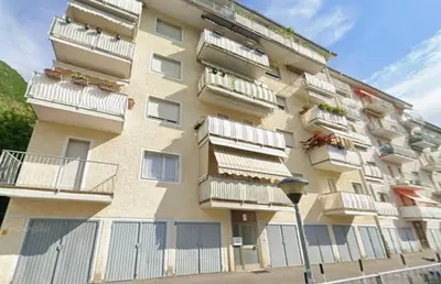 a large apartment building with balconies and a street light at CasaFlavondiBolzano in Bolzano