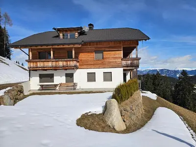 a large wooden house in the snow with snow at Urlaub auf den Bauernhof Brunnerhof in Floronzo