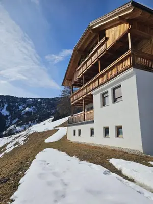 a building on top of a snow covered mountain at Urlaub auf den Bauernhof Brunnerhof in Floronzo