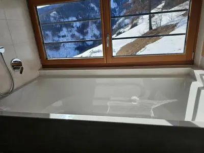 a bath tub in a bathroom with a window at Urlaub auf den Bauernhof Brunnerhof in Floronzo