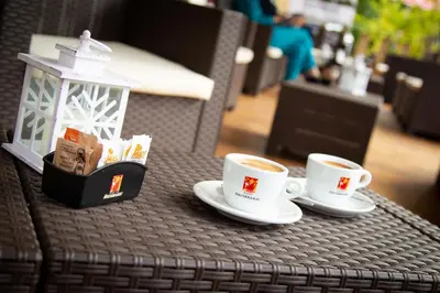 two cups of coffee sitting on a table at Camping Castelpietra in Fiera di Primiero