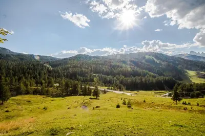 a grassy field with a view of a mountain at Garni Baita in San Cassiano