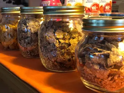 a row of jars of food sitting on a counter at Garni al Barance in Selva di Cadore
