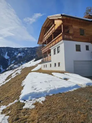 a house on top of a hill with snow at Urlaub auf den Bauernhof Brunnerhof in San Lorenzo di Sebato