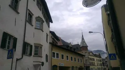 a city street with buildings and a clock tower at Casa Laurino In Centro A Bolzano in Bolzano