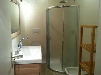 a bathroom with a sink and a glass shower at Casa Laurino In Centro A Bolzano in Bolzano