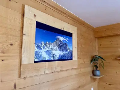 a window in a wall with a picture of a mountain at Dolomites Red Heart Lake View in Masarè