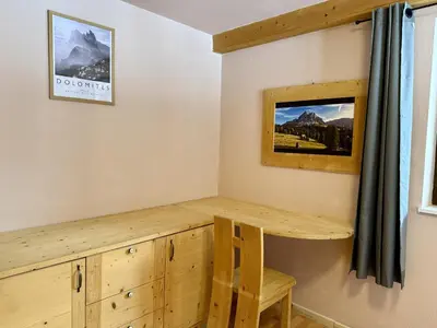 a wooden desk in a room with a window at Dolomites Red Heart Lake View in Masarè