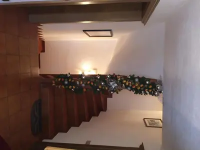 a staircase in a church with a christmas decoration at Residence Vajolet San Cassiano in San Cassiano