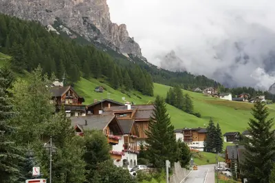 a village in the mountains with a mountain at Residence Vajolet San Cassiano in San Cassiano