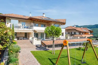 a house with a yard with a swing at Angerhof in Caldaro