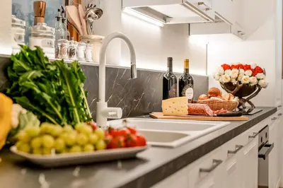 a kitchen counter with a sink and fruits and vegetables at Chalet Mortisa, Cortina design apartment in Col