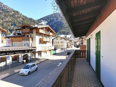 a white car parked on a street in a town at Apartment Cesa Marco by Interhome in Pozza di Fassa