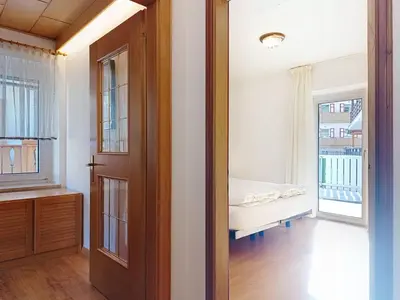 an open door to a room with a bed and a window at Apartment Cesa Marco by Interhome in Pozza di Fassa