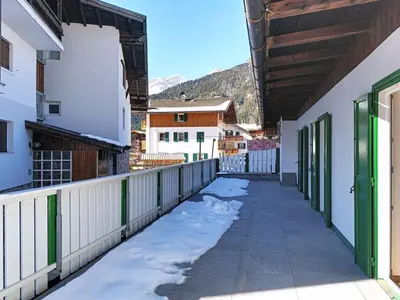 a walkway between buildings with snow on the ground at Apartment Cesa Marco by Interhome in Pozza di Fassa
