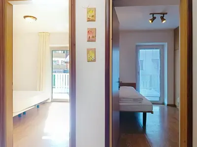 a view of a room with a bed and a mirror at Apartment Cesa Marco by Interhome in Pozza di Fassa