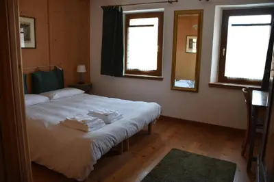 a bedroom with a bed with towels on it at Mezzodì Locazione Turistica in Colcerver