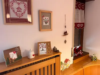 a mantle with christmas cards and pictures on it at Angolo relax in Cencenighe