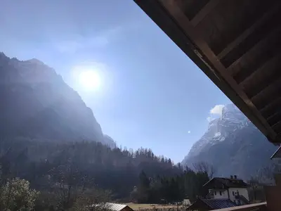 a view of a snowy mountain from a train window at Angolo relax in Cencenighe