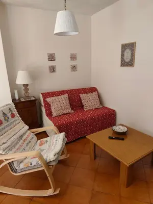 a kitchen with white cabinets and a table and chairs at Angolo relax in Cencenighe