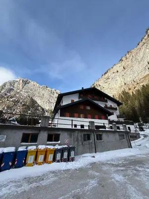 a building in the mountains with snow on the ground at Malga Ciapela e Marmolada a due passi dalle piste in Malga Ciapela