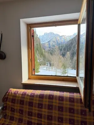 a window with a view of a mountain view at Malga Ciapela e Marmolada a due passi dalle piste in Malga Ciapela