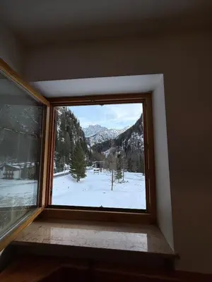 a window with a view of a snow covered mountain at Malga Ciapela e Marmolada a due passi dalle piste in Malga Ciapela