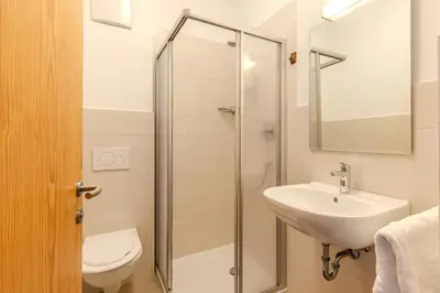 a bathroom with a toilet and a sink and a shower at Zischgalm in Obereggen