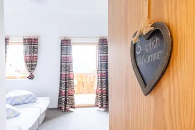 a heart shaped sign on a wall in a bedroom at Zischgalm in Obereggen